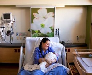 Danica Lafay DeMoy-Allers, the first baby born in the new McIntire Birthing Center at Kootenai Health, is held by her mother Tessa DeMoy on Wednesday. Danica was born Tuesday evening at seven pounds, 11 ounces, and a lengthy 21.5 inches long. (Jake Parrish/Press photo)