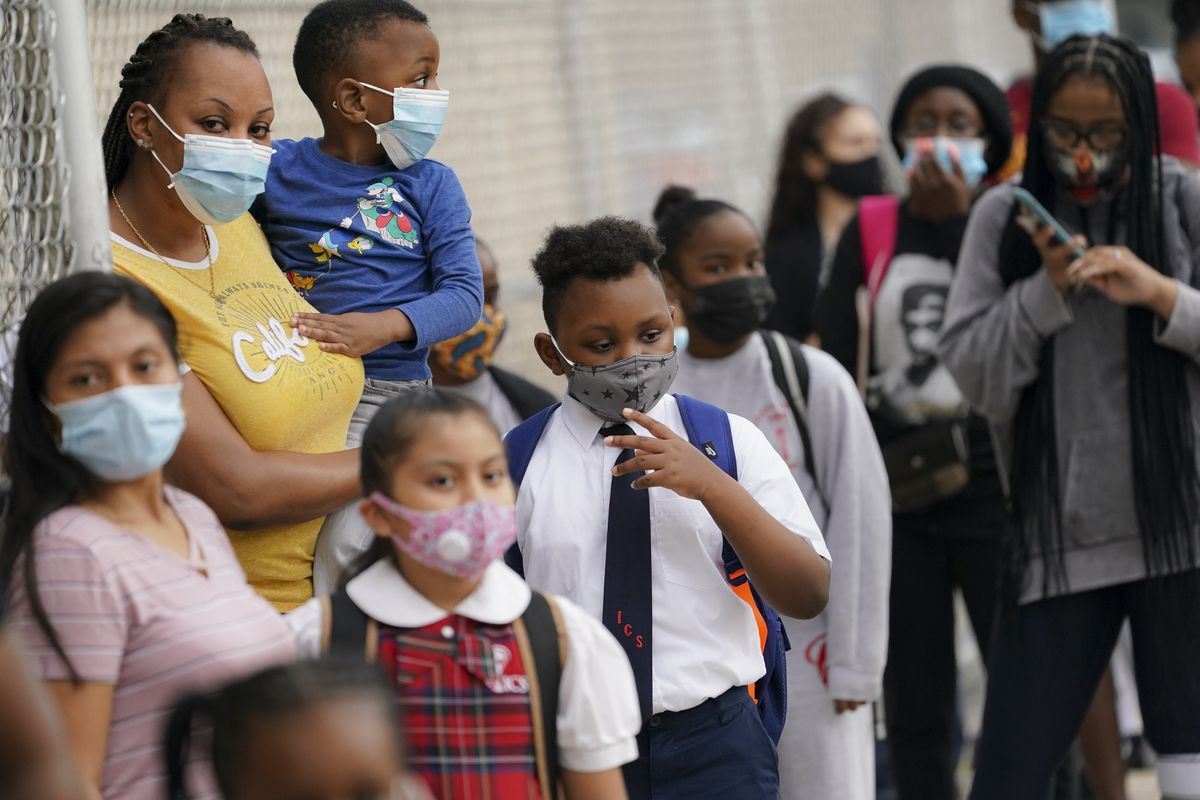 Students wear protective masks as they arrive for classes on Sept. 9 at the Immaculate Conception School while observing COVID-19 prevention protocols in The Bronx borough of New York.  (John Minchillo)