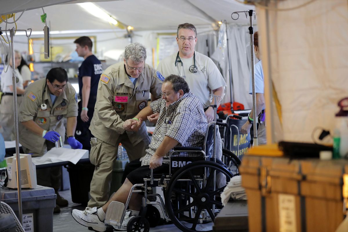 A Panama City resident, who did not want his name used, receives medical treatment, inside the Florida 5 Disaster Medical Assistance Team tent, outside the Bay Medical Sacred Heart hospital, in the aftermath of Hurricane Michael in Mexico Beach, Fla., Thursday, Oct. 18, 2018. (Gerald Herbert / AP)