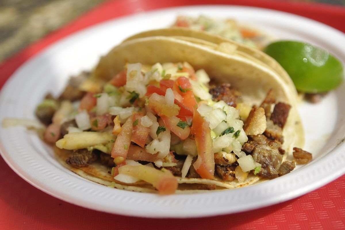 Atilano’s is cheap and fast, and that’s why it’s a popular spot for college students. Pictured here are one carne asada taco and one carnitas taco. (Adriana Janovich / The Spokesman-Review)