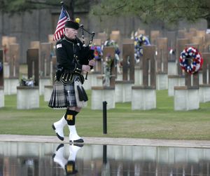Pipe Sergeant Kevin M. Donnelly, of the DEA Black and Gold Pipes and Drums, walks past the Field of Chairs and the Reflecting Pool at the Oklahoma City National Memorial, Monday, April 19, 2010 to start the memorial ceremony on the 15th anniversary of the Oklahoma City bombing, in Oklahoma City. (Sue Ogrocki / Associated Press)