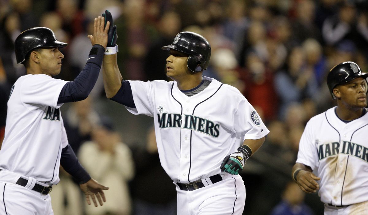 M’s Jose Lopez, right, is congratulated by Ronny Cedeno after his three-run home run in the fifth.  (Associated Press / The Spokesman-Review)