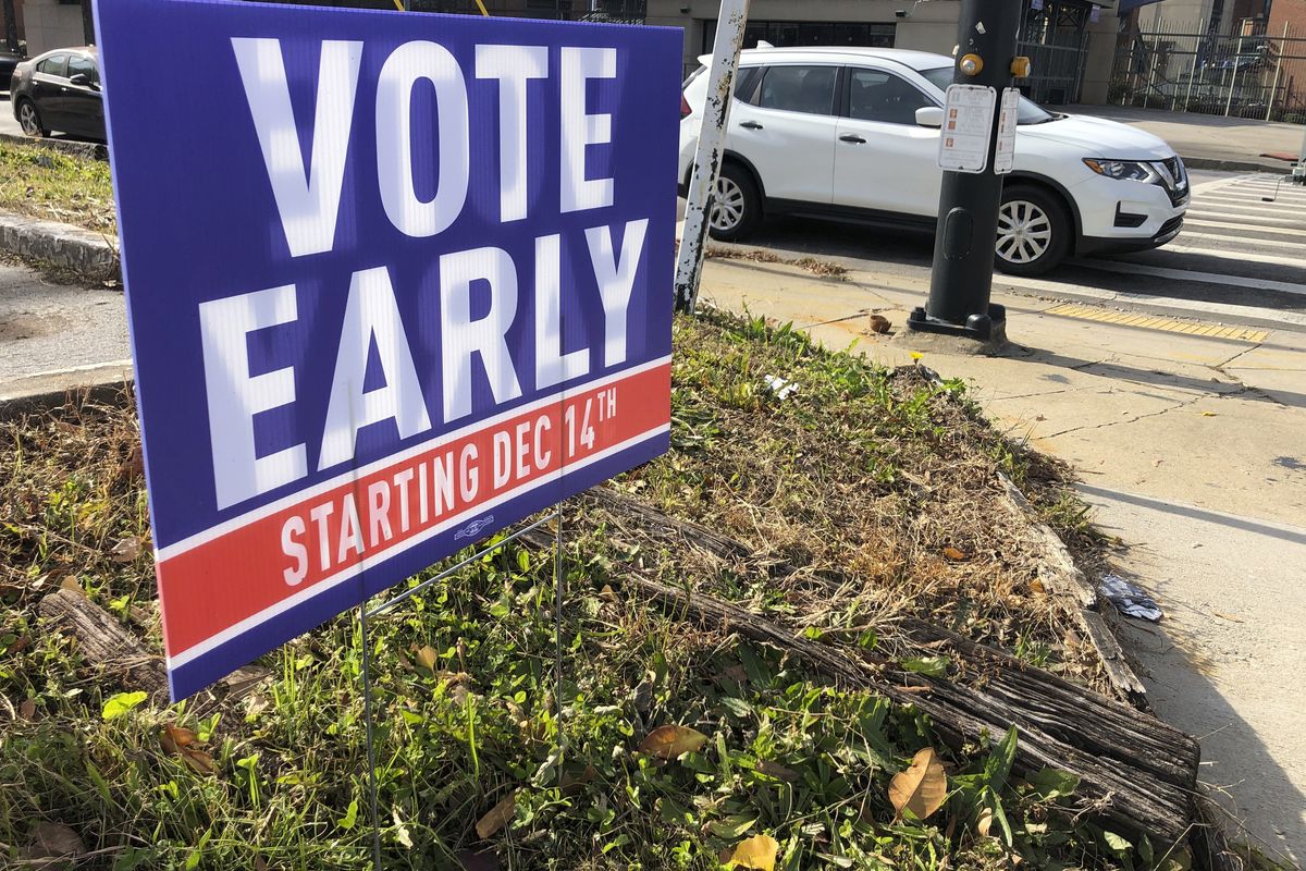 A sign in an Atlanta neighborhood on Friday, Dec. 11, 2020, urges people to vote early in Georgia