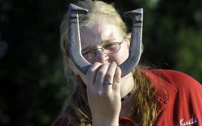 Washington state Girls Junior horseshoe champion Kaiti Reeves aims her toss during a practice at Franklin Park July 22. (PHOTOS BY CHRISTOPHER ANDERSON / The Spokesman-Review)
