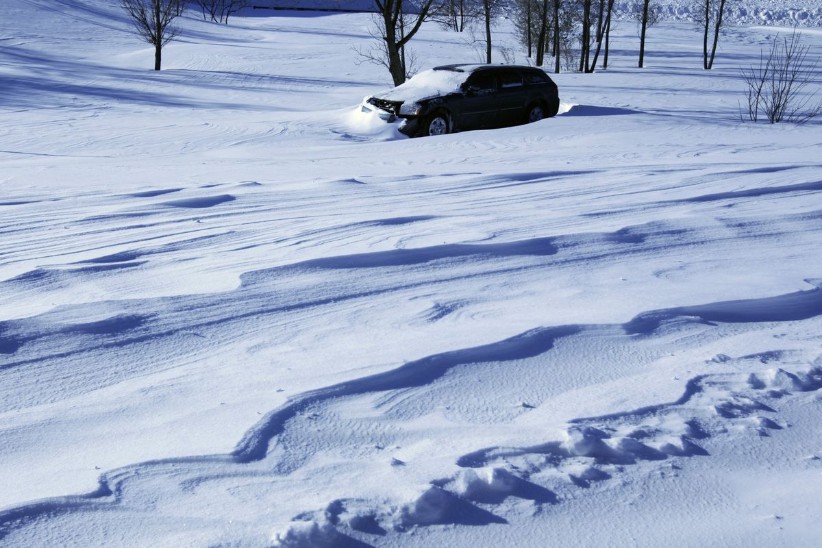 A vehicle sits in a ditch off I-94 in Minneapolis on Sunday after a powerful storm.  (Associated Press)