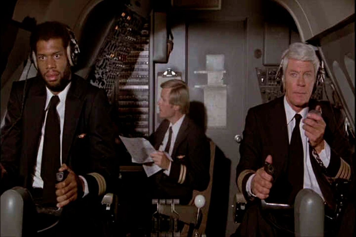 Kareem Abdul-Jabbar and Peter Graves appear in a scene from the 1980 comedy “Airplane!” (Paramount)