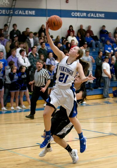 Coeur d’Alene’s Erin Legel goes up for a layup on a fast break as Post Falls’ Lexi Smith defends in the third quarter. (BRUCE TWITCHELL)