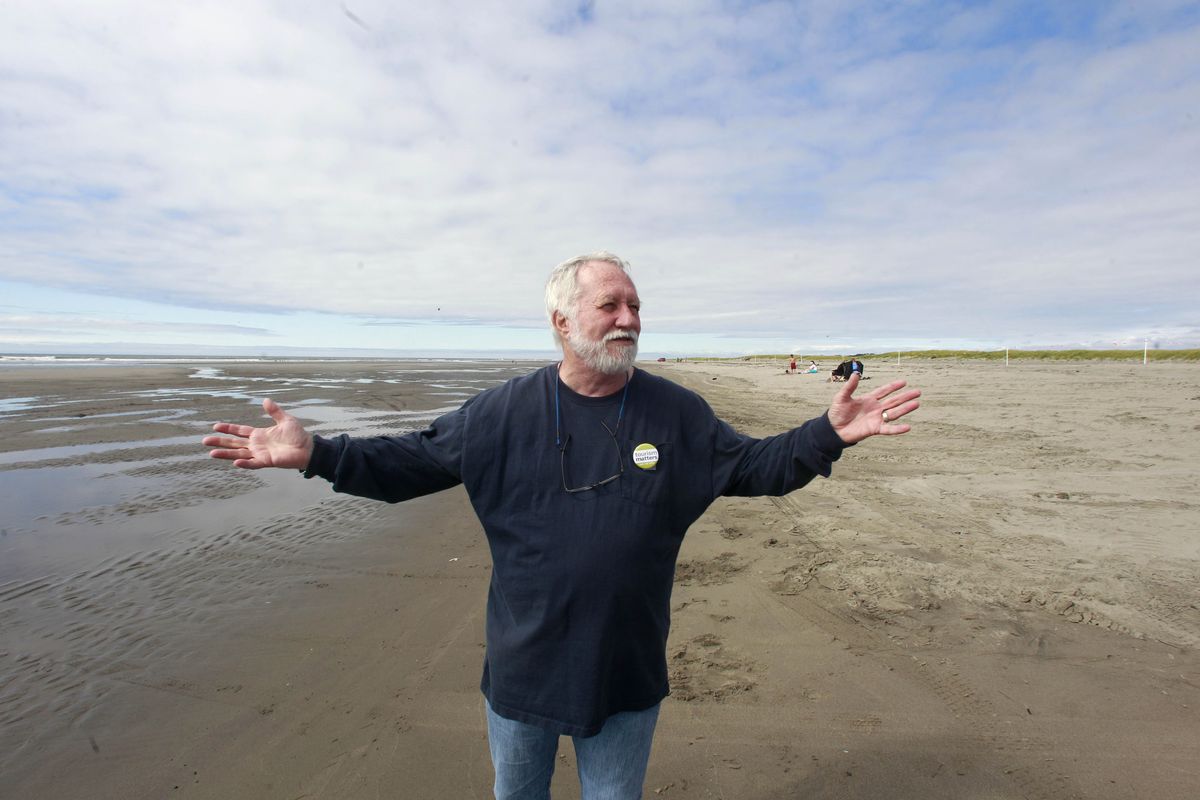Long Beach, Wash., City Administrator Gene Miles walks along the beach Aug. 10, discussing tsunami plans. (Associated Press)