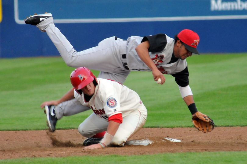 Spokane Indians' Nickolaus Vickerson is tagged out at second but manages to break up a double play by tripping up Salem-Keizer's Julio Izturis, Friday, June 17, 2011, at Avista Stadium during opening night of the Indians' 2011 season. (Jesse Tinsley / The Spokesman-Review)