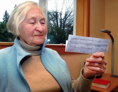 Betty Longshore holds a statement in Port Angeles, Wash., notifying her that about $17,000 had been taken from her bank by the government, which mistakenly declared her dead. (Associated Press)