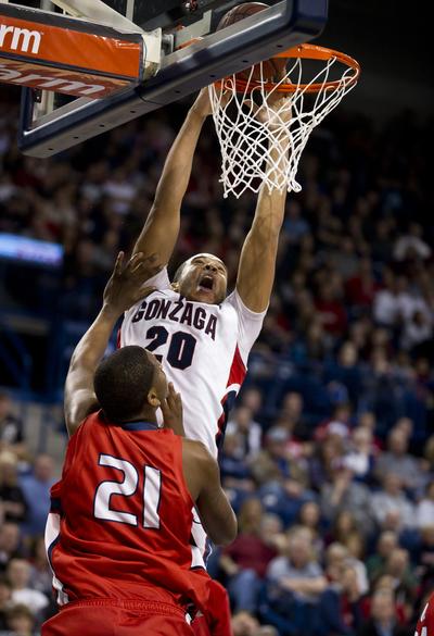 Gonzaga’s Elias Harris  powers over Lewis-Clark State's Alex King for two of his game-high 19 points.  (Colin Mulvany)