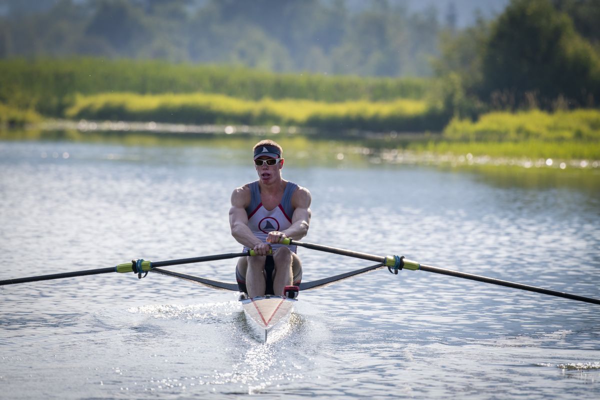 Isaiah Harrison, a national champion rower in his age group, rows his tiny boat back to his family boat dock on Wolf Lodge Creek off of Lake Coeur d’Alene Friday, July 23, 2021. He rows mostly on the lake, which is near his family home and is headed to the world championships in Bulgaria in August.  (Jesse Tinsley/THE SPOKESMAN-REVI)