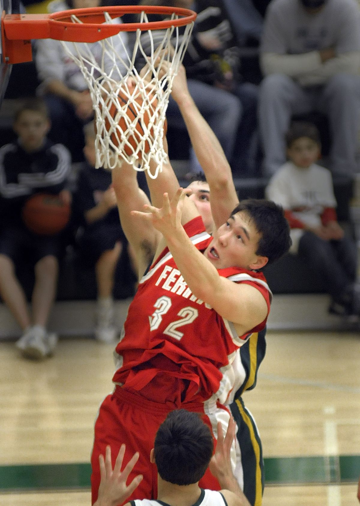 Taylor Kamitomo of Ferris crashes inside to control a defensive rebound against Shadle Park.  (CHRISTOPHER ANDERSON / The Spokesman-Review)