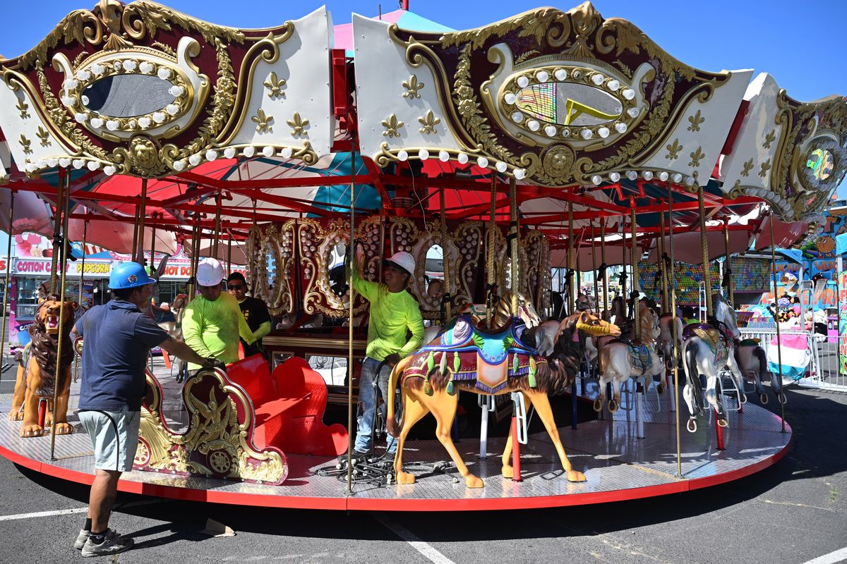 Some of the 200 workers set up a classic carousel at the Butler Amusements carnival at the Spokane Interstate Fair on Thursday at the Spokane Fair & Expo Center in Spokane. The fair opens Friday.  (Jesse Tinsley/THE SPOKESMAN-REVIEW)