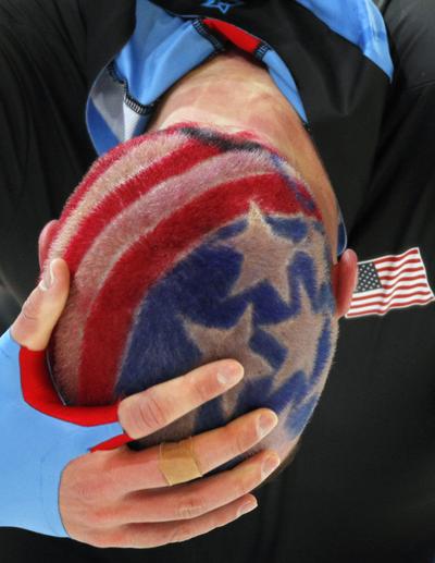 USA's Ryan Bedford, the American flag seen in his hair, reacts after his race during the men's 10,000 meter speed skating race at the Richmond Olympic Oval at the Vancouver 2010 Olympics in Vancouver, British Columbia, Tuesday, Feb. 23, 2010. (Chris Carlson / Associated Press)