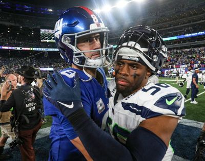 New York Giants quarterback Daniel Jones, left, gets a hug from Seattle linebacker Jordyn Brooks after the Seahawks’ 24-3 win on Oct. 2 in East Rutherford, N.J. (Tribune News Service)