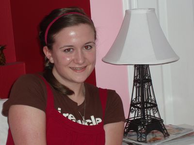 Christy Finley sits next to her Eiffel Tower lamp in her bedroom. Finley spent the past year teaching fourth-graders at Trentwood Elementary how to speak French.  (Rainey Coffin / The Spokesman-Review)