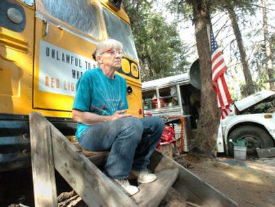 
Bryan Russell's mother, Marcia Stevenson, sits outside one of the buses where her son and his family lived in rural Ferry County. Stevenson still lives on the rural property.
 (Joe Barrentine / The Spokesman-Review)