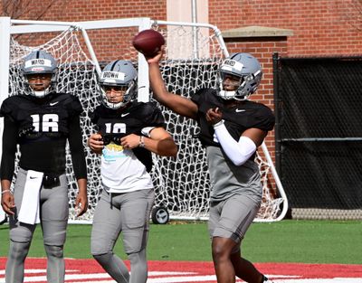 Washington State quarterback Cameron Ward, right, throws a pass during a spring camp practice Saturday at Rogers Field in Pullman.  (WSU Athletics)