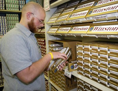 Thomas Choate unpacks cartons of Winston cigarettes at a tobacco outlet store in Statesville, N.C., in 2005. Reynolds American Inc., the nation’s No. 2 tobacco company, says smuggling of its cigarettes is a major black-market moneymaker. (Associated Press)
