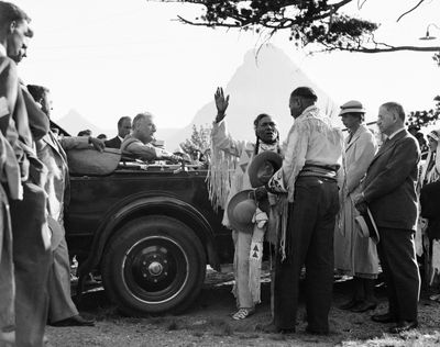 In this Aug. 5., 1934,  photo, President Franklin D. Roosevelt and  Eleanor Roosevelt are inducted into the Blackfeet tribe near Two-Medicine Chalet, Glacier National Park. After the president had been installed as “Lone Chief,”  Eleanor Roosevelt received the title of “Medicine Pipe Woman.”  (Associated Press)