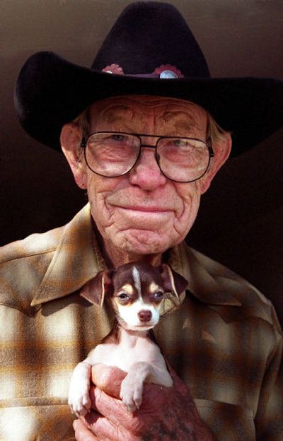 
Dog breeder Bill Bonham holds a 2-month-old Chihuahua puppy. Toy breeds require special care.
 (Los Angeles Times / The Spokesman-Review)