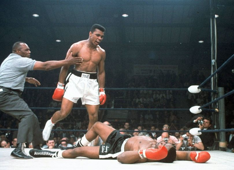 In this May 25, 1965, file photo, heavyweight champion Muhammad Ali is held back by referee Joe Walcott, left, after Ali knocked out challenger Sonny Liston in the first round of their title fight in Lewiston, Maine. Ali, the magnificent heavyweight champion whose fast fists and irrepressible personality transcended sports and captivated the world, has died according to a statement released by his family Friday, June 3, 2016. He was 74.  