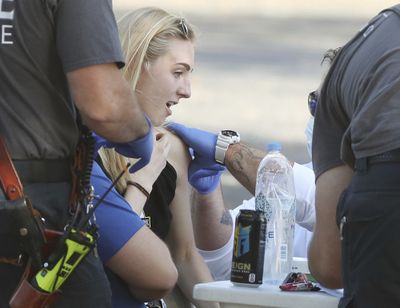 A health-care worker reacts as she receives the COVID-19 vaccine at Lake-Sumter State College in Leesburg, Fla., on Friday, Jan. 1, 2021. Long lines of cars were at the site as the Lake County vaccines are currently being given to people who are 65 years and older and front line workers. (Associated Press)