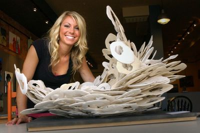 Jaque Meng and her sculpture, Big Bang Theory, at Antwiqued, 309 W. Second Ave., in downtown Spokane. (Brian Plonka / The Spokesman-Review)