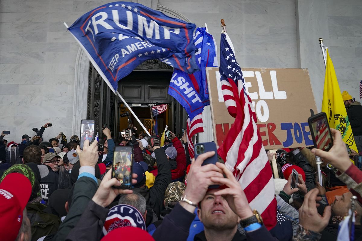 FILE - In this Jan. 6, 2021, file photo, Trump supporters gather outside the Capitol in Washington. Online supporters of Trump are scattering to smaller social media platforms, fleeing what they say is unfair treatment by Facebook, Twitter and other big tech firms looking to squelch misinformation and threats of violence.  (John Minchillo)