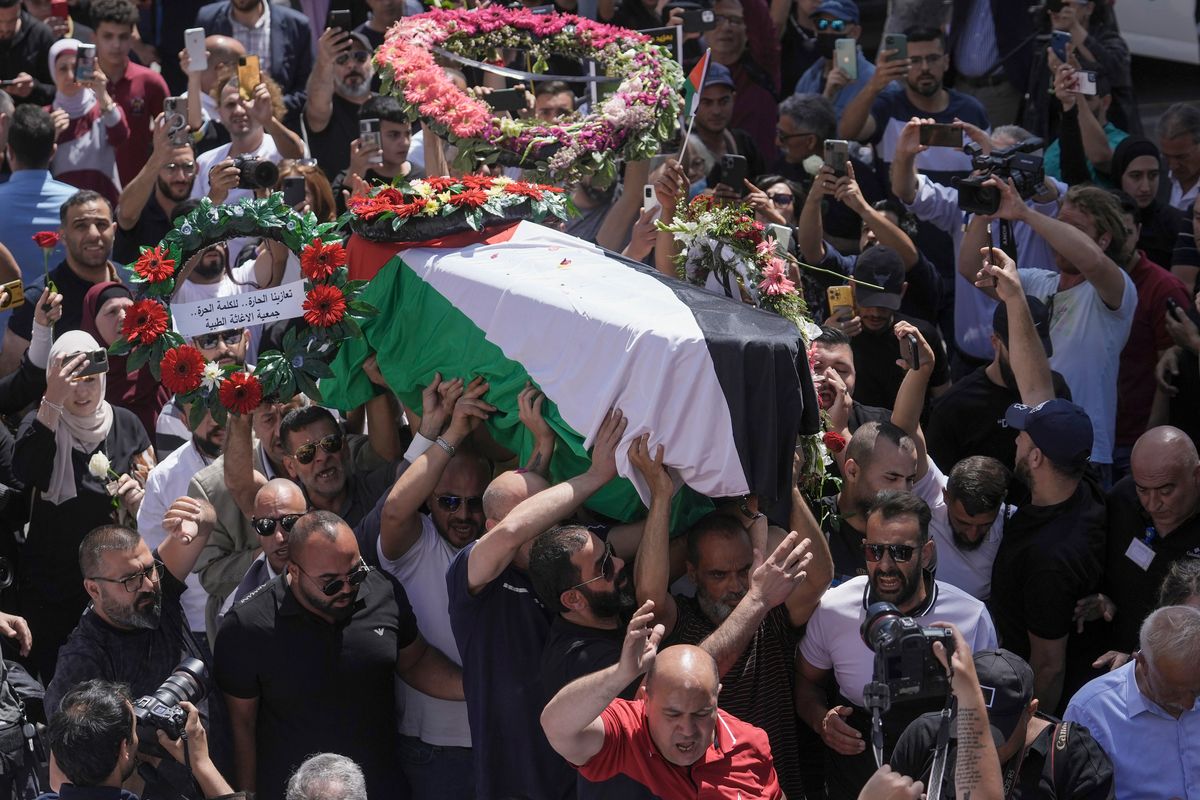 Family, friends and colleagues of slain Al Jazeera journalist Shireen Abu Akleh carry her coffin to a hospital in the east Jerusalem neighborhood of Sheikh Jarrah, Thursday, May 12, 2022. Abu Akleh, a Palestinian-American reporter who covered the Mideast conflict for more than 25 years, was shot dead Wednesday during an Israeli military raid in the West Bank town of Jenin.  (Mahmoud Illean)