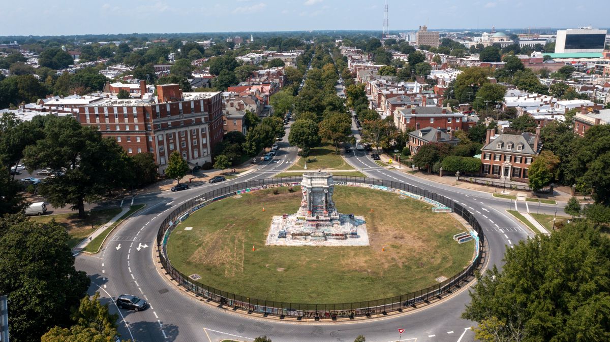 FILE - The pedestal that once held the statue of Confederate General Robert E. Lee stands empty on Monument Avenue in Richmond, Va., Tuesday, Sept. 14, 2021. The pedestal has been covered in graffiti, with some describing it as a work of protest art that should be left in place.  (Steve Helber)