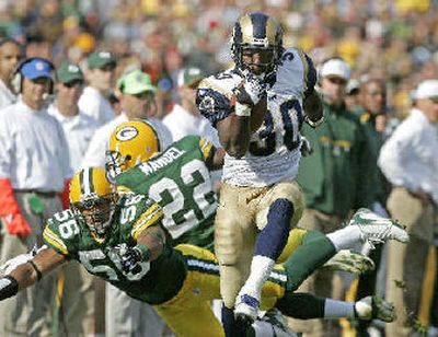 
 Rams' Tony Fisher breaks away for a 40-yard pass reception during the fourth quarter. 
 (AP / The Spokesman-Review)