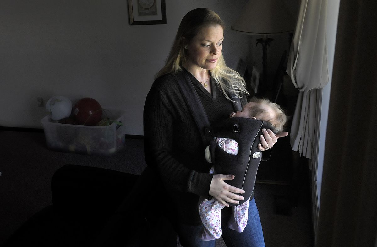 Courtney Lindberg stands at the front window of her home in Colbert. After a drug labeling mix-up, her daughter Lindsay is healthy and home.  (Photos by CHRISTOPHER ANDERSON / The Spokesman-Review)