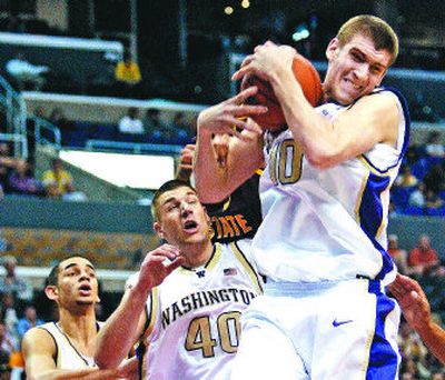 
Washington's Spencer Hawes, right, grabs a rebound against Arizona State in front of teammate Jon Brockman. 
 (Associated Press / The Spokesman-Review)
