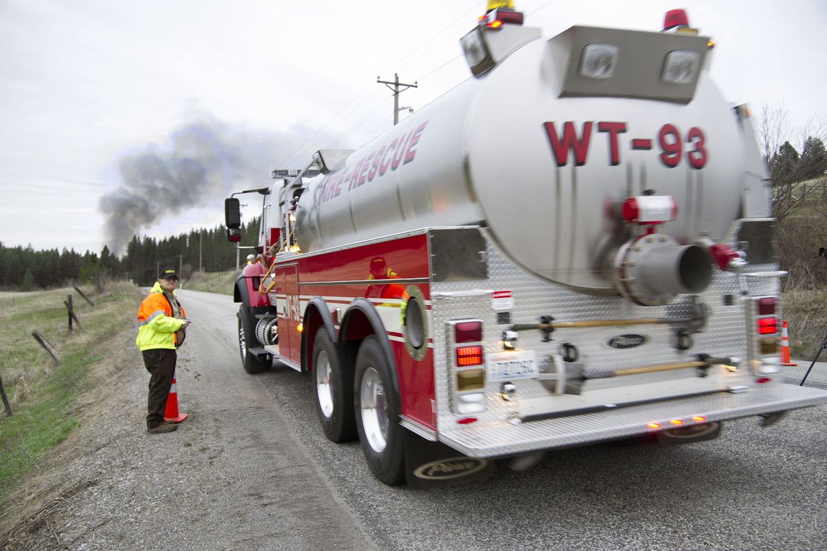 A Fire District 9 water tanker heads to a residence fire at 13819 N. Forker Road on Thursday night.