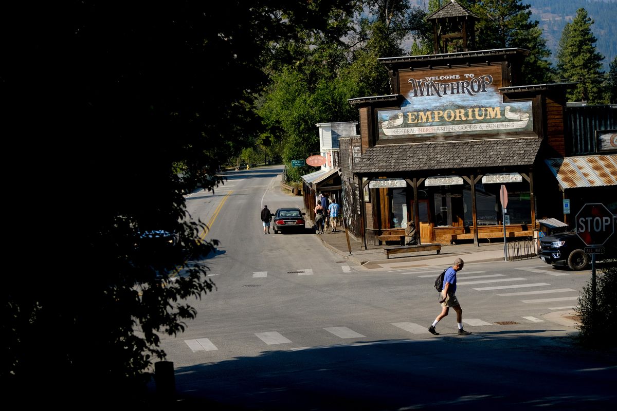 A man crosses a street on Friday morning in Winthrop, Wash.  (Tyler Tjomsland/The Spokesman-Review)