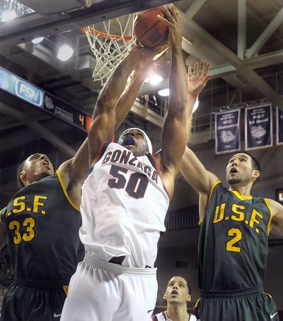 Ira Brown of Gonzaga splits San Francisco defenders #33 Dior Lowhorn and #2 Blake Wallace to grab an offensive rebound during their game Saturday, Jan. 17, 2009, in Spokane. (Christopher Anderson / The Spokesman-Review)
