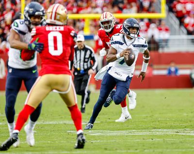 Seattle Seahawks quarterback Geno Smith takes off and rushes for a first down against the San Francisco 49ers on Sunday at Levi’s Stadium in Santa Clara, Calif.  (Tribune News Service)