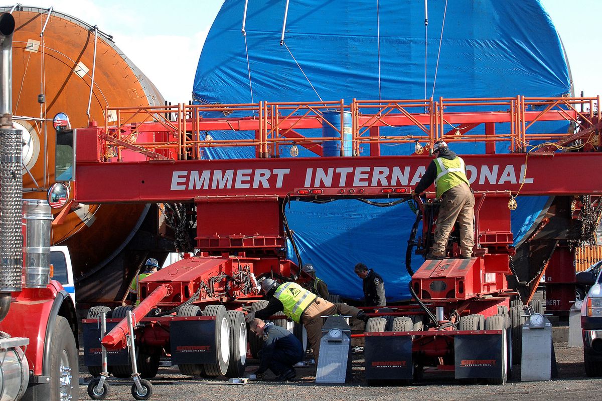 Crews from Emmert International prepare an oversized load Monday in Lewiston. (Associated Press)