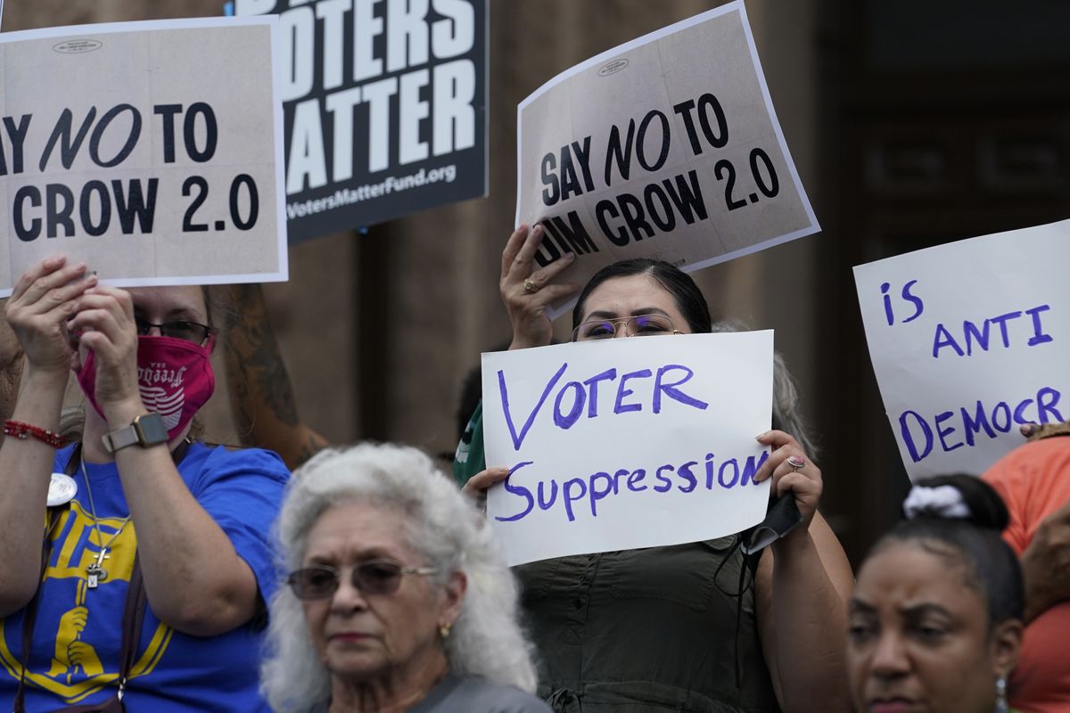 Demonstrators join a rally to protest proposed voting bills on the steps of the Texas Capitol on July 13, 2021, in Austin, Texas. A sweeping new Texas voting law that Republicans muscled through the Legislature last year over dramatic protests is drawing fire again, even before some of the most contentious restrictions and changes kick in ahead of the state