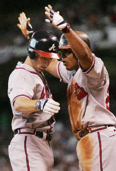 
Atlanta Braves' Adam LaRoche, left, is greeted at homeplate by teammate Andruw Jones after he hit a three-run homer.
 (Associated Press / The Spokesman-Review)