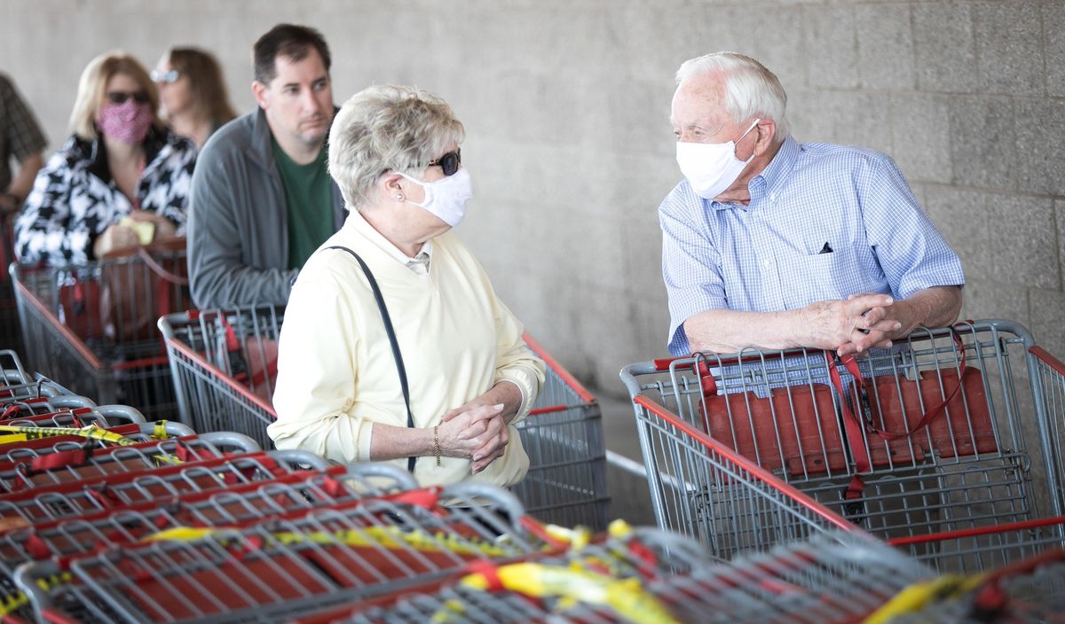 Customers wait in line to enter the Costco on Sprague Avenue in Spokane Valley, Wash. on April 9, 2020. The wholesale store implemented a policy of limiting the number of customers in the store at any given time in order to enforce social distancing to prevent the spread of COVID-19. (Libby Kamrowski / The Spokesman-Review)