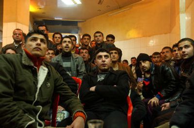 
Iraqis watch the Asian Games soccer tournament final between Iraq and Qatar in Sulaimaniyah, 160 miles northeast of Baghdad, on Friday. Iraq lost the final to Qatar 0-1. 
 (Associated Press photos / The Spokesman-Review)