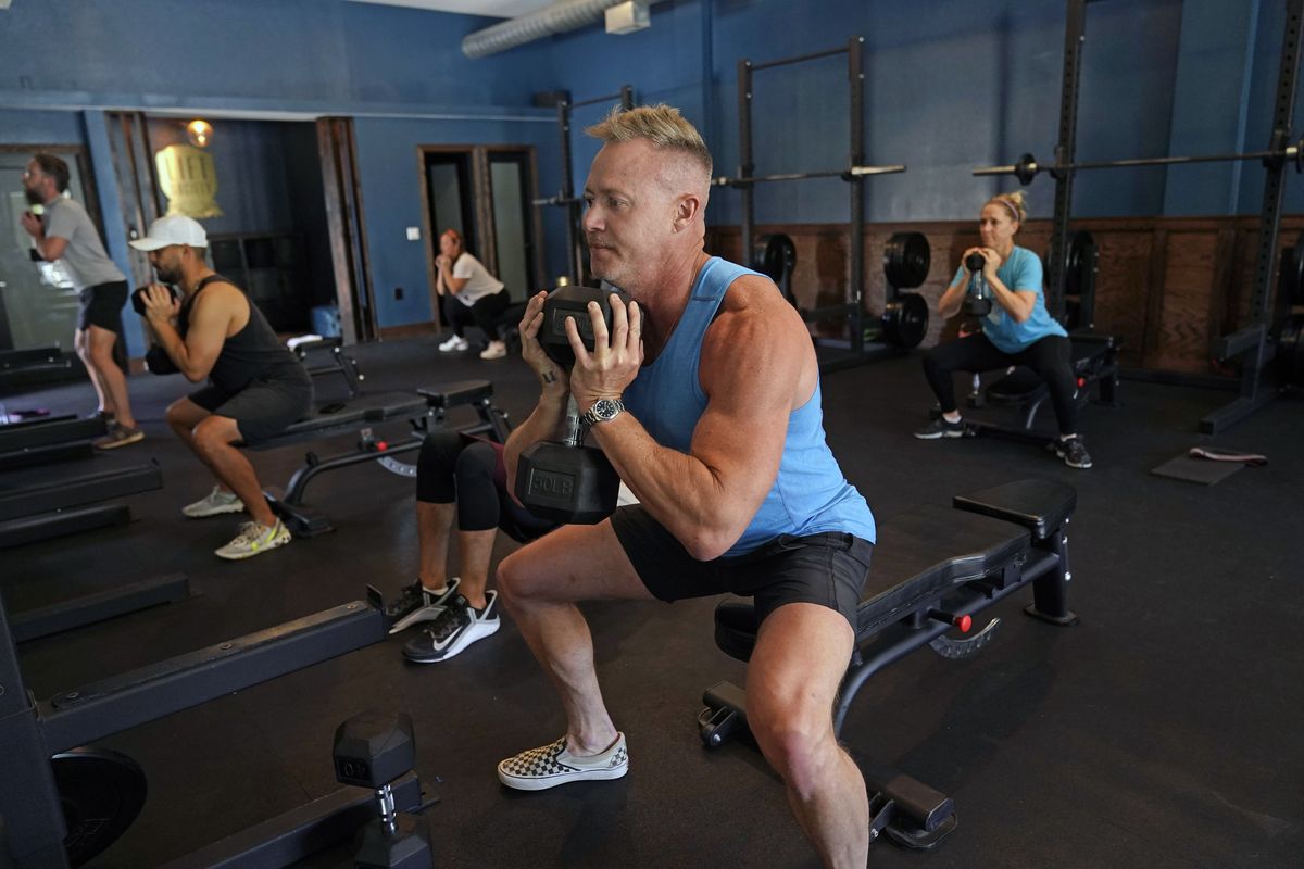 Scott Johnson, foreground in blue, participates in a fitness class at Lift Society Friday, May 21, 2021, in Studio City, Calif. California