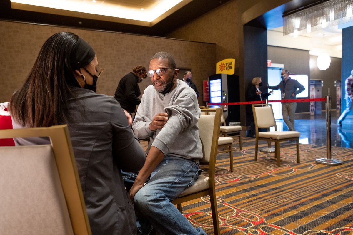 Larry Gaines receives a coronavirus booster shot at a vaccine clinic being held at Maryland’s Live! Casino & Hotel in Hanover.  (Allison Shelley/Washington Post)