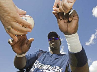 
Milwaukee Brewers' Bill Hall signs an autograph during a spring training baseball workout at the team's facility.
 (Associated Press / The Spokesman-Review)