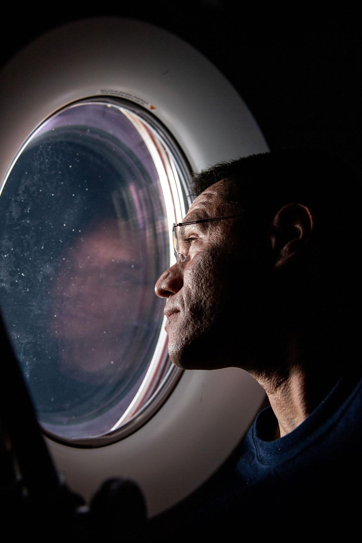 NASA astronaut Frank Rubio peers out of a window aboard the SpaceX Dragon Freedom spacecraft docked to the International Space Station in 2022. MUST CREDIT: Bob Hines/NASA  (Bob Hines/Bob Hines)