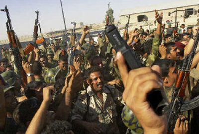 
Iraqi soliders celebrate the capture of suspected insurgents in Tal Afar on Tuesday. Story on page A9. 
 (Associated Press / The Spokesman-Review)