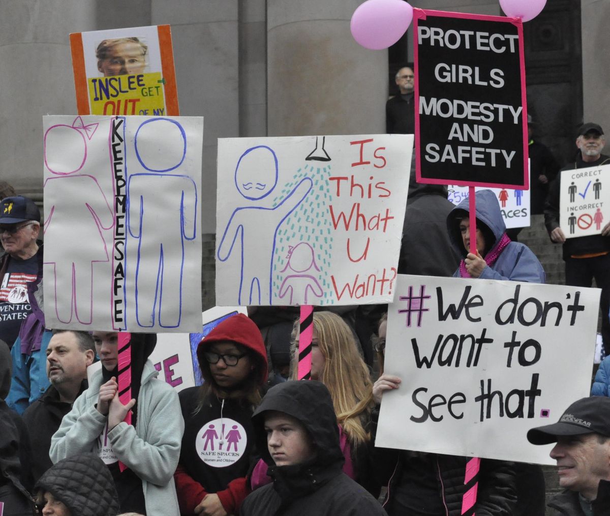 OLYMPIA – Protesters gathered on the Capitol steps last February to denounce a rule that transgender people can use public restrooms and locker rooms based on their gender identity rather than their anatomy. (Jim Camden / The Spokesman-Review)